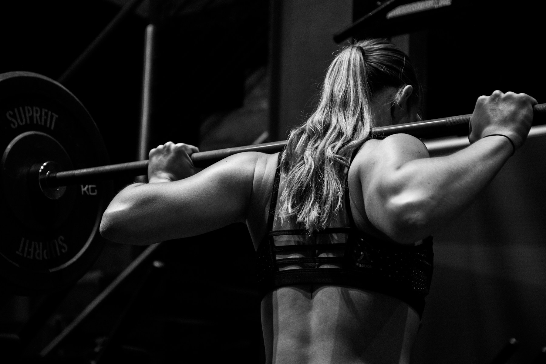 Athlete lifting a barbell in a gym